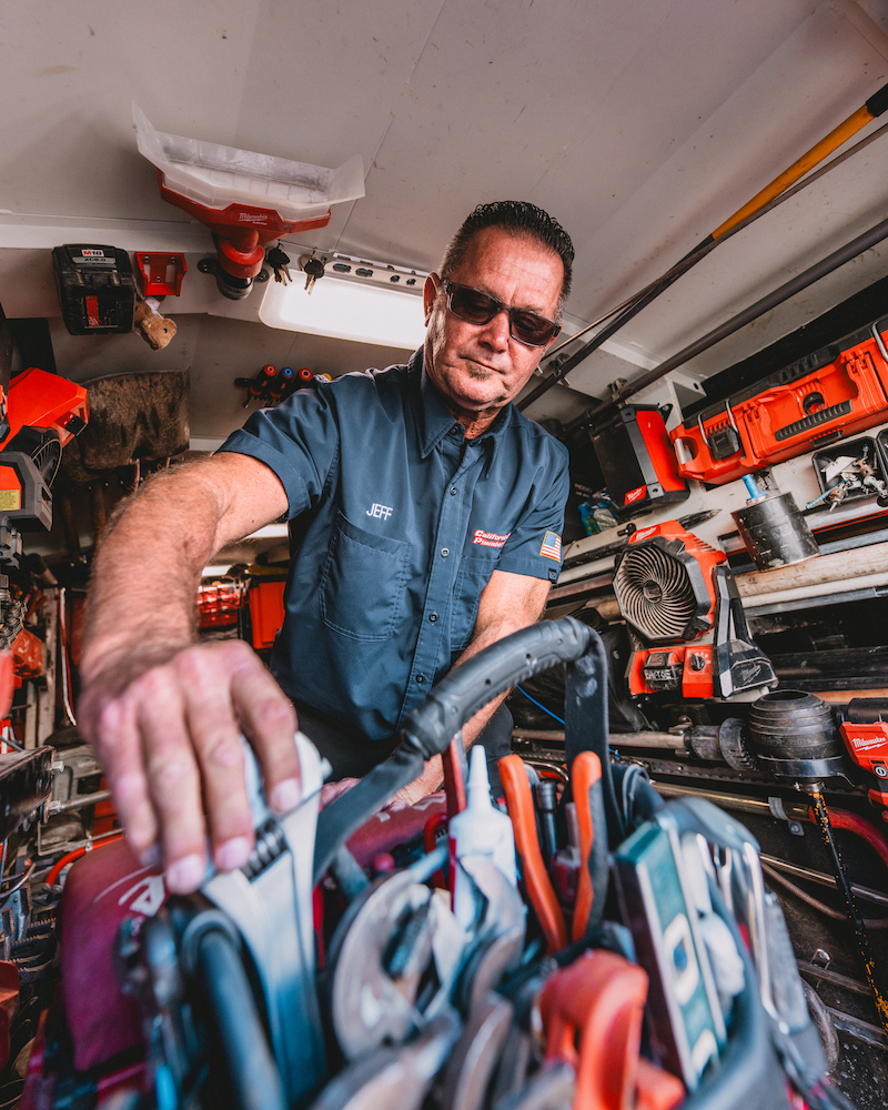 Jeff Gores, founder of California Coast Plumbers, inside a work van